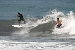 Two surfers on a small right.