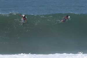 Carlos Muñoz and Gilbert Brown paddling for the next wave in Playa Hermosa.