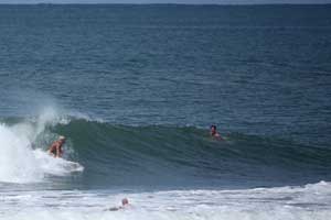 Surfing a wave while your buddies are watching.